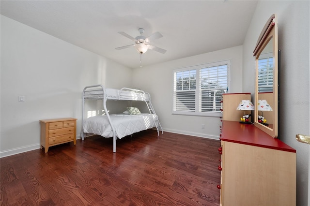 bedroom with dark hardwood / wood-style floors and ceiling fan