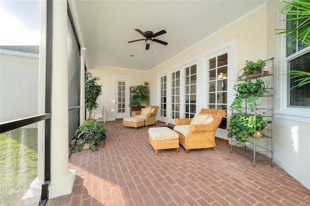 sunroom / solarium featuring ceiling fan