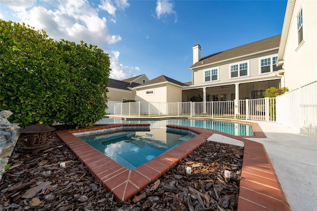 view of swimming pool featuring a sunroom