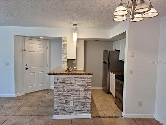 kitchen featuring decorative light fixtures, kitchen peninsula, white cabinets, and appliances with stainless steel finishes