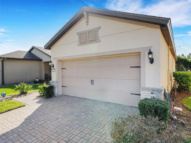 garage featuring decorative driveway