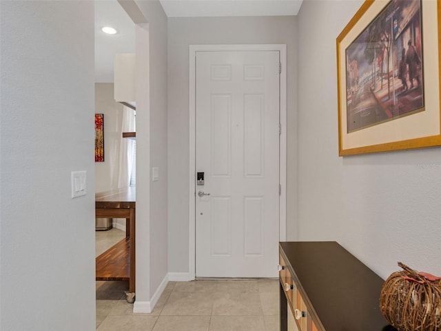 foyer with light tile patterned floors and baseboards