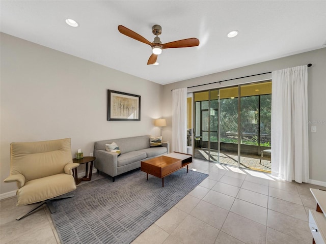 living area featuring light tile patterned floors, ceiling fan, baseboards, and recessed lighting