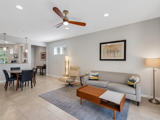 living area featuring baseboards, light tile patterned floors, recessed lighting, and a healthy amount of sunlight