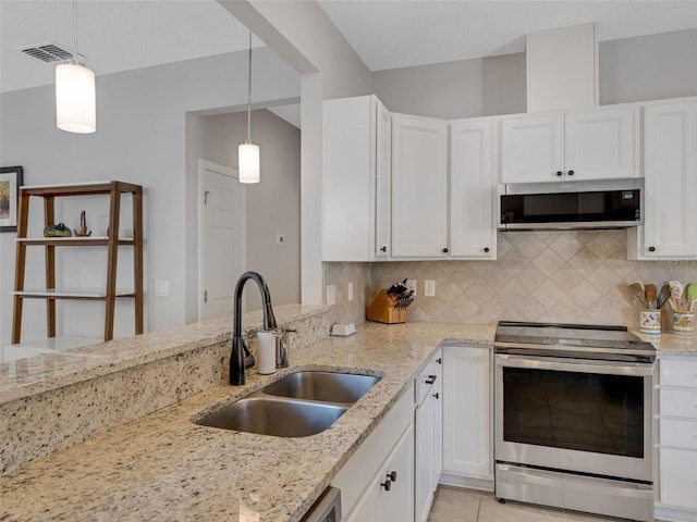 kitchen featuring appliances with stainless steel finishes, visible vents, a sink, and tasteful backsplash