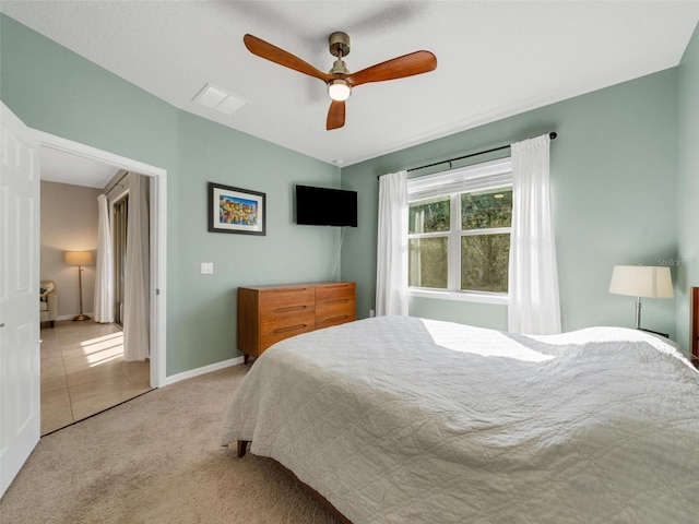 bedroom with carpet floors, ceiling fan, visible vents, and baseboards