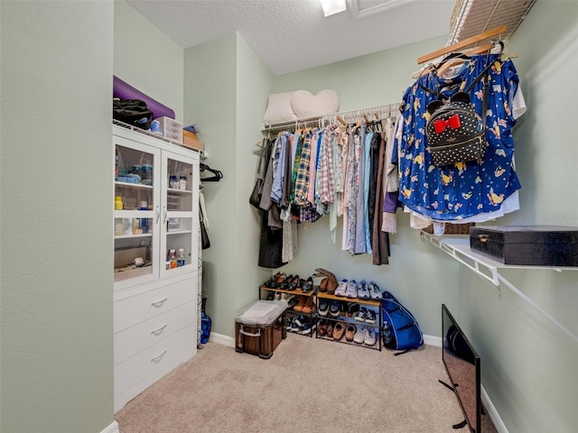 walk in closet with carpet flooring