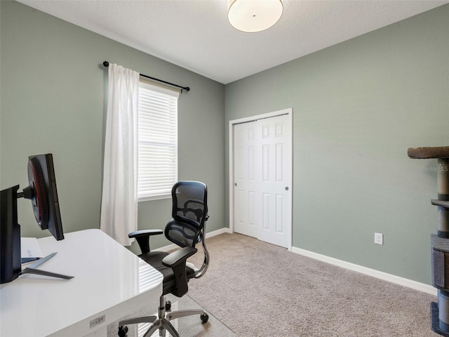 home office featuring carpet and baseboards