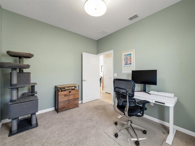 carpeted office space featuring baseboards and visible vents