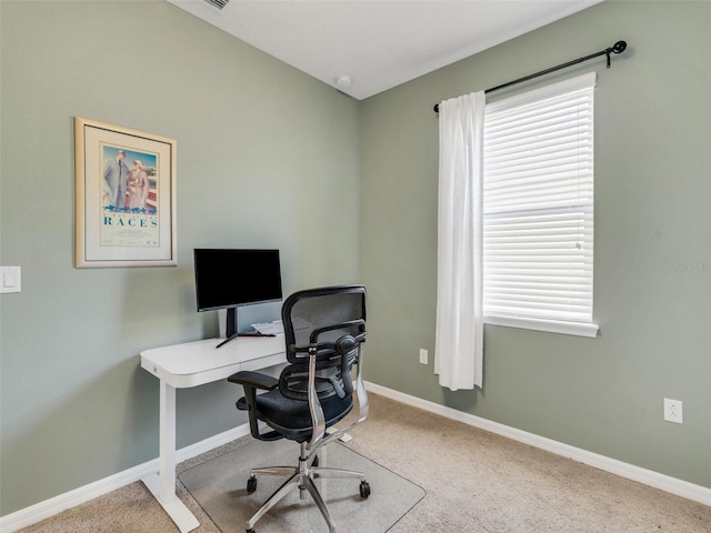 carpeted office space featuring a wealth of natural light and baseboards