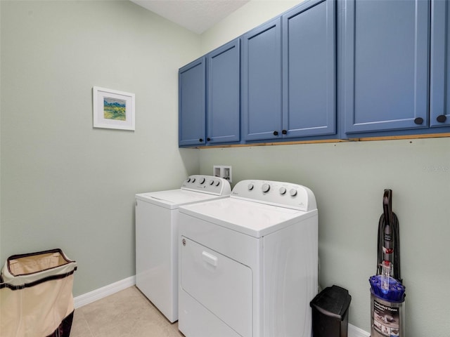 washroom featuring cabinet space, independent washer and dryer, baseboards, and light tile patterned floors