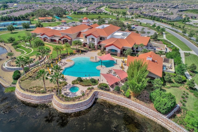 drone / aerial view featuring a residential view and a water view