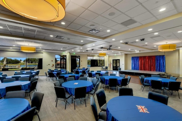 interior space with baseboards, visible vents, a drop ceiling, and recessed lighting