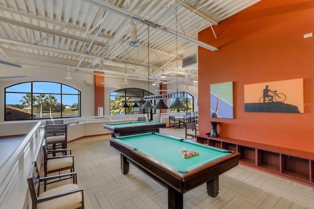 rec room with pool table and a high ceiling