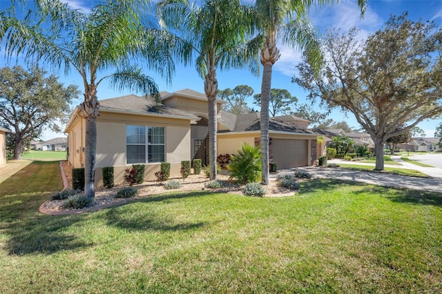 view of front of home featuring a front lawn and a garage