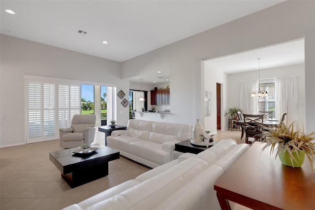 living room featuring a chandelier and light tile patterned floors