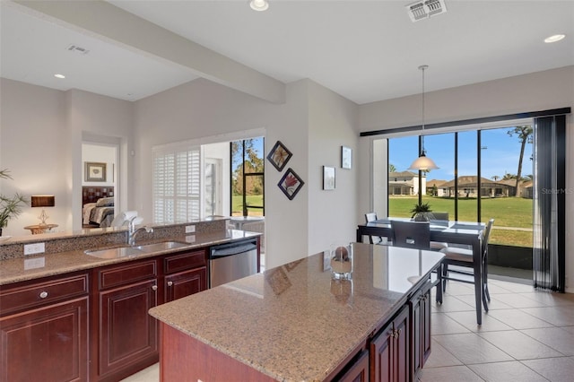 kitchen with hanging light fixtures, a center island, light stone countertops, sink, and dishwasher