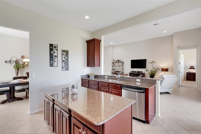 kitchen featuring light tile patterned floors, sink, light stone counters, stainless steel dishwasher, and kitchen peninsula