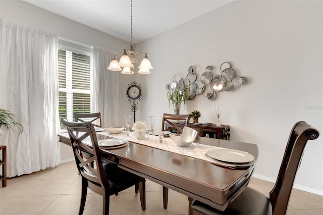 tiled dining space featuring a notable chandelier