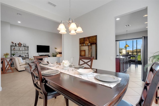 dining room with light tile patterned flooring and an inviting chandelier