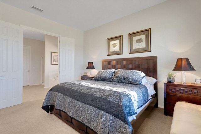 carpeted bedroom with ensuite bath