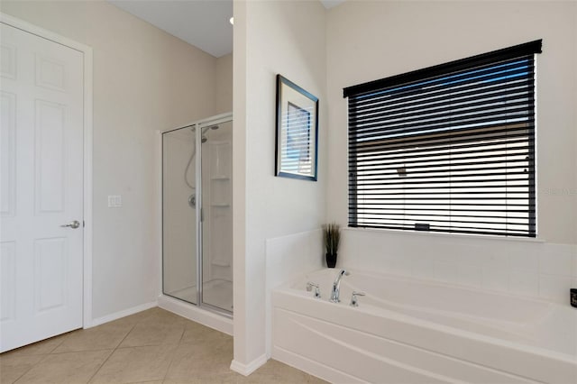 bathroom featuring tile patterned flooring and shower with separate bathtub