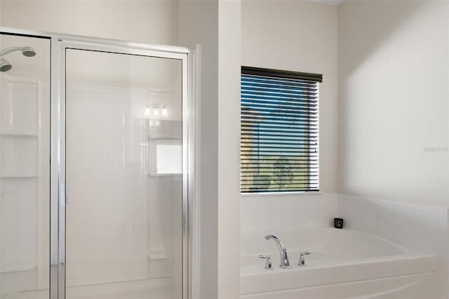 bathroom featuring independent shower and bath