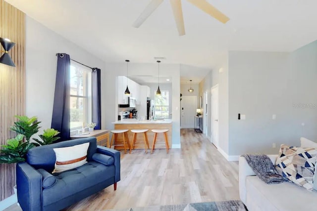 living room featuring a wealth of natural light and light wood-type flooring