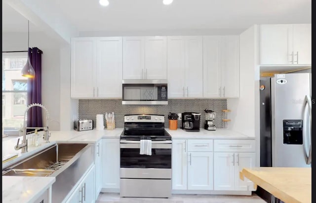 kitchen featuring white cabinetry and stainless steel appliances