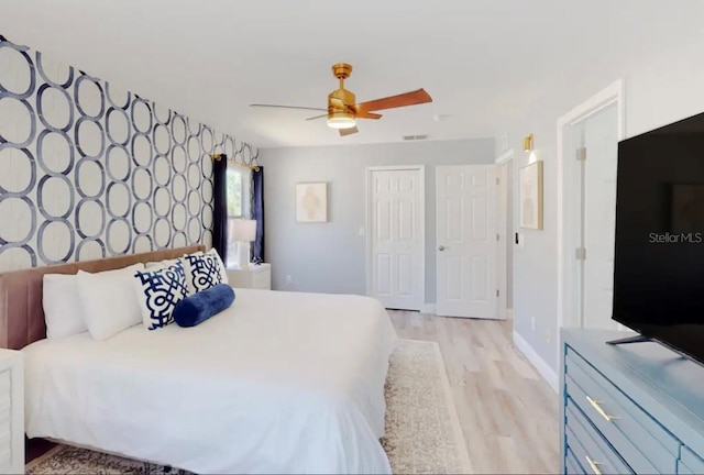 bedroom with light hardwood / wood-style flooring, a closet, and ceiling fan