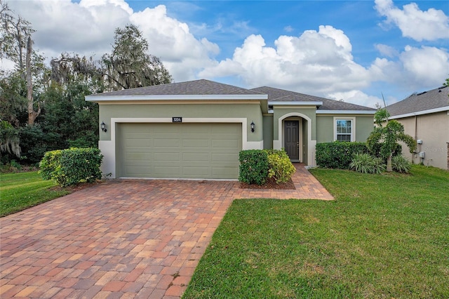 ranch-style home with a garage and a front yard