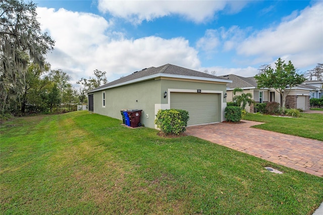 view of home's exterior with a garage and a yard