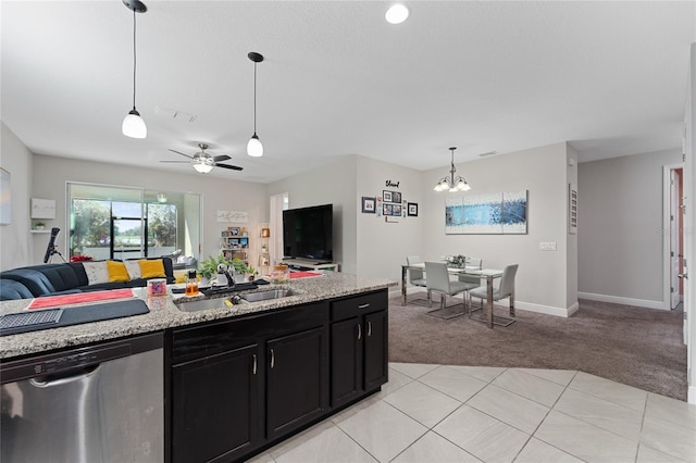 kitchen featuring dishwasher, sink, hanging light fixtures, light stone countertops, and light carpet