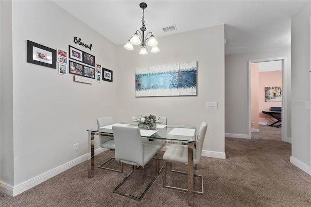 dining space with a notable chandelier and carpet flooring