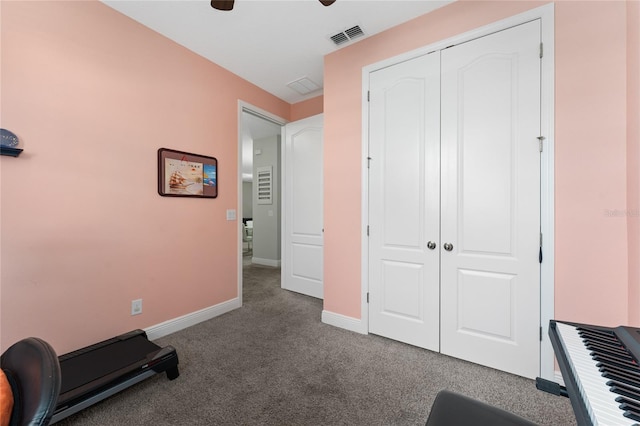 exercise area featuring ceiling fan and carpet