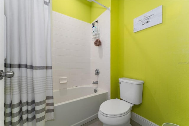 bathroom with toilet and shower / bath combo with shower curtain