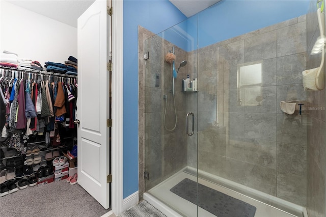 bathroom featuring a shower with shower door