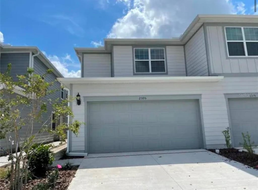 view of front of house with a garage and concrete driveway