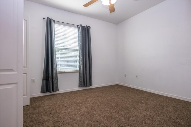 unfurnished room featuring ceiling fan and dark colored carpet