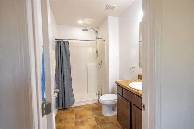 bathroom featuring a shower with curtain, vanity, tile patterned flooring, and toilet