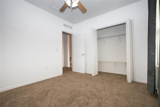 unfurnished bedroom featuring carpet flooring, ceiling fan, and a closet