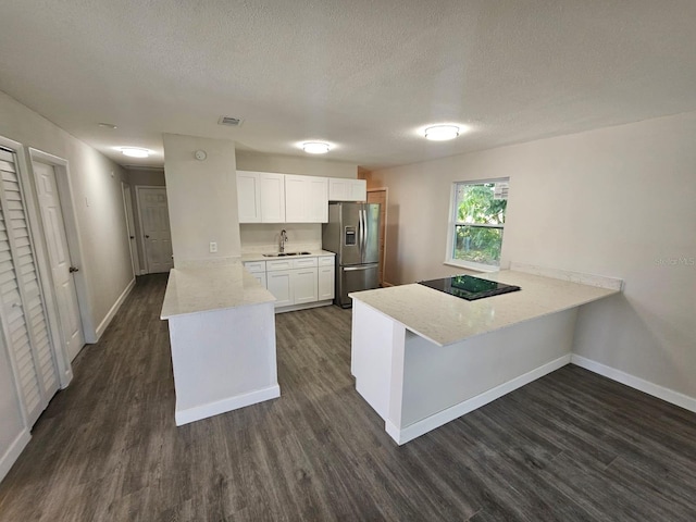 kitchen featuring stainless steel refrigerator with ice dispenser, sink, white cabinetry, dark hardwood / wood-style flooring, and kitchen peninsula