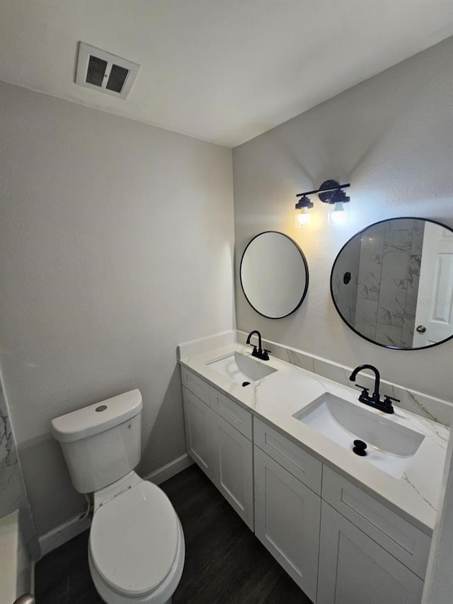 bathroom featuring vanity, hardwood / wood-style floors, and toilet