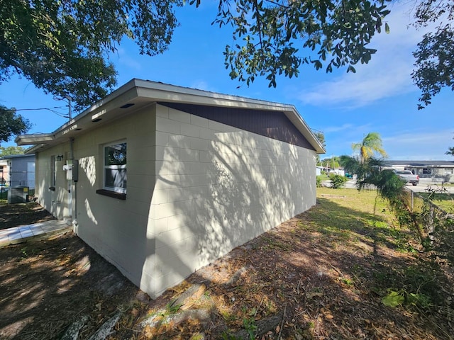 view of side of home featuring central AC unit