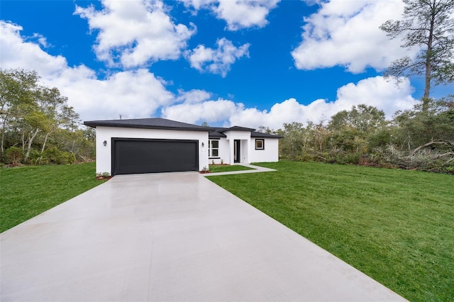 view of front of property featuring a garage and a front lawn