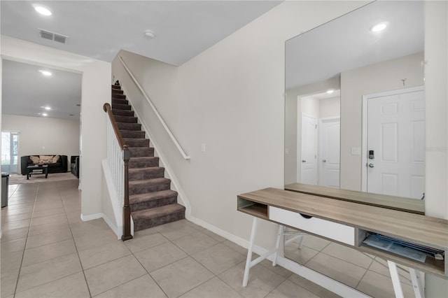 stairway featuring tile patterned floors