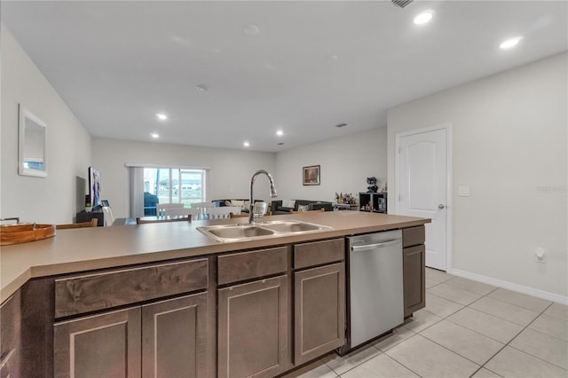 kitchen with dark brown cabinetry, sink, light tile patterned floors, and dishwasher