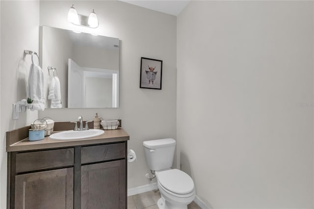 bathroom with tile patterned floors, vanity, and toilet