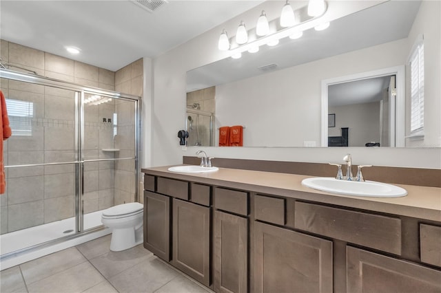 bathroom with vanity, toilet, an enclosed shower, and tile patterned flooring