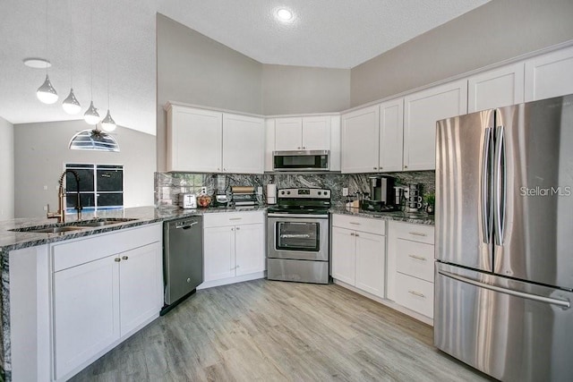 kitchen featuring pendant lighting, sink, white cabinetry, and appliances with stainless steel finishes